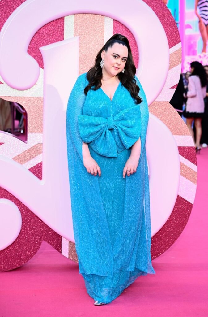 Scottish actress Sharon Rooney posing in a promotional photo for the BBC reality show Celebrity Traitors series two, Scottish actress Sharon Rooney known for My Mad Fat Diary and Barbie looking toward the camera, Official cast announcement graphic for Celebrity Traitors featuring actress Sharon Rooney, Sharon Rooney standing in front of a dark castle backdrop for The Traitors promotional material